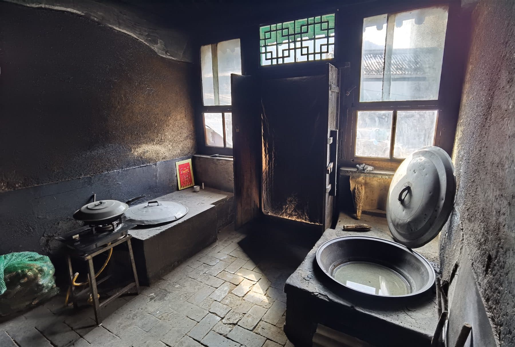 Old village kitchen interior with stove and cooking tools